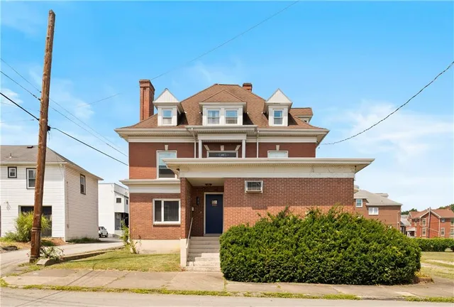 a front view of a house with a yard