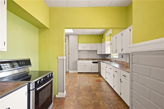 a kitchen that has a sink and a stove