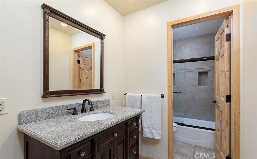 5935 Aluffo Road Paso Robles, CA 93446 - Photo 11 of 43 a bathroom with a granite countertop sink and a mirror