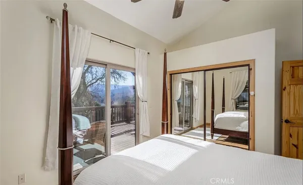 a bedroom with a bed and large window