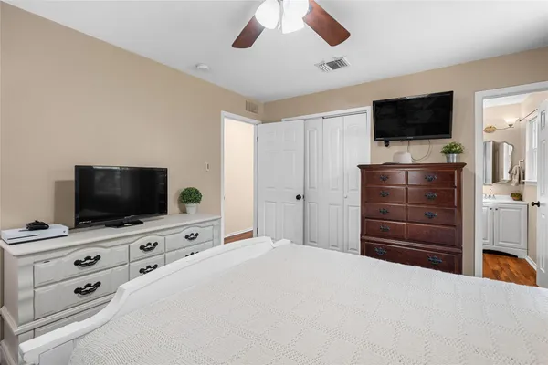 a bedroom with a bed and flat screen tv