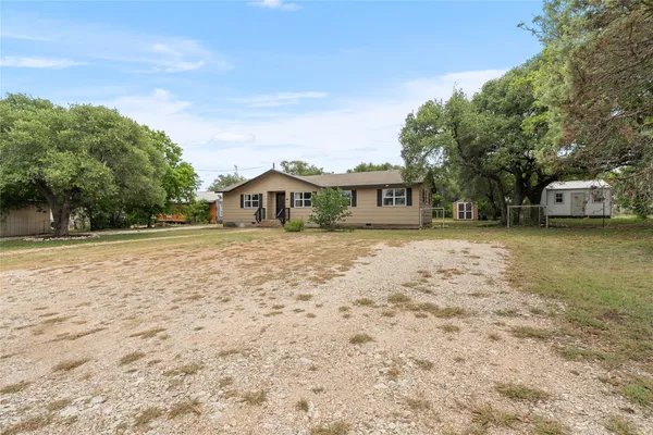 a view of a house with a yard and sitting area
