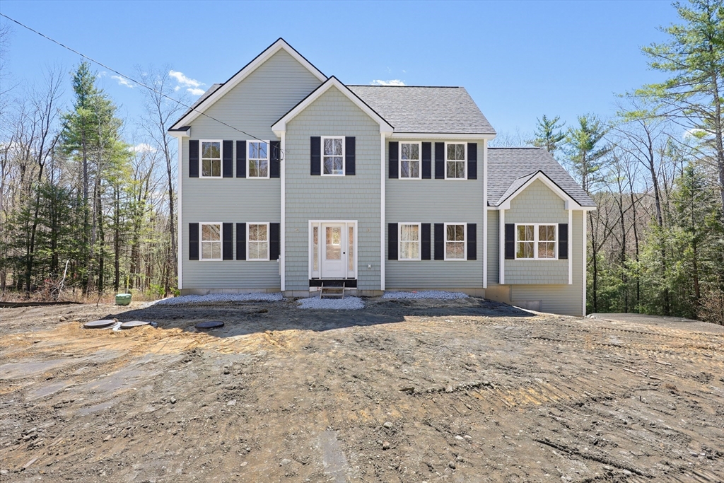 112 West Meadow Road Townsend, MA 01474 - Photo 38 of 38 a front view of a house with a yard and trees
