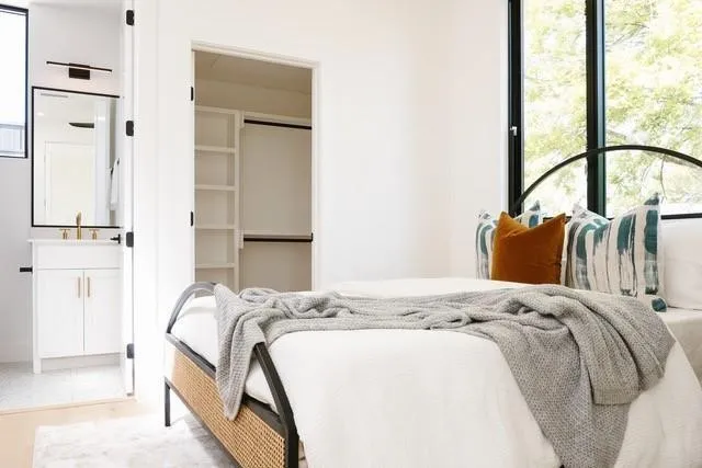 a bedroom with a bed and a window