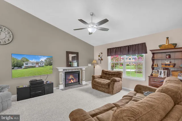 a living room with fireplace furniture and a flat screen tv