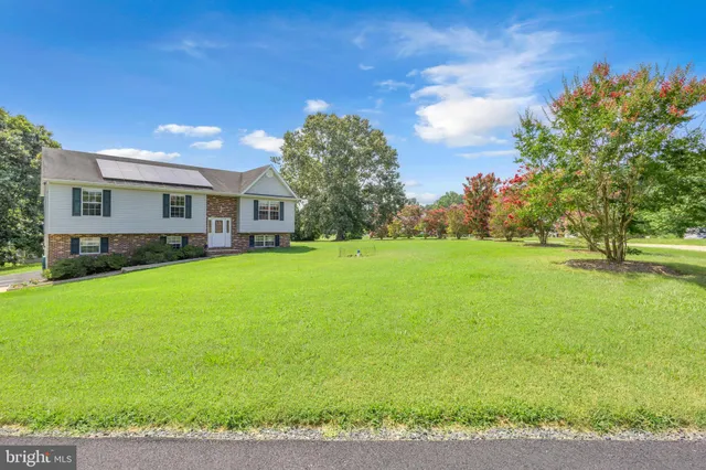 a house view with swimming pool and trees in the background