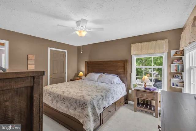 a bedroom with a large bed and a chandelier
