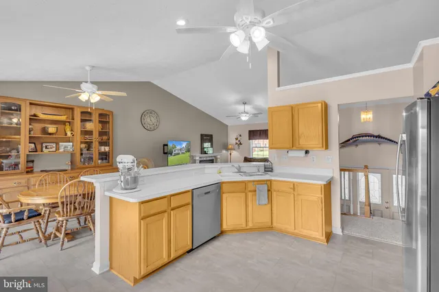 a kitchen with a sink a counter top space appliances and cabinets