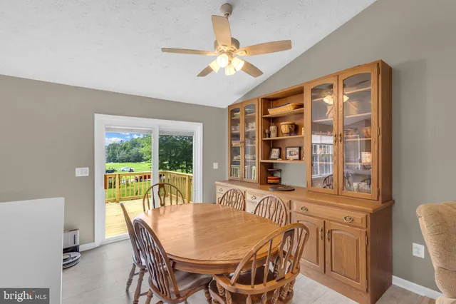 a dining room with furniture large windows and a chandelier