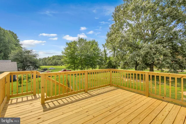 a view of a balcony with wooden floor and outdoor space