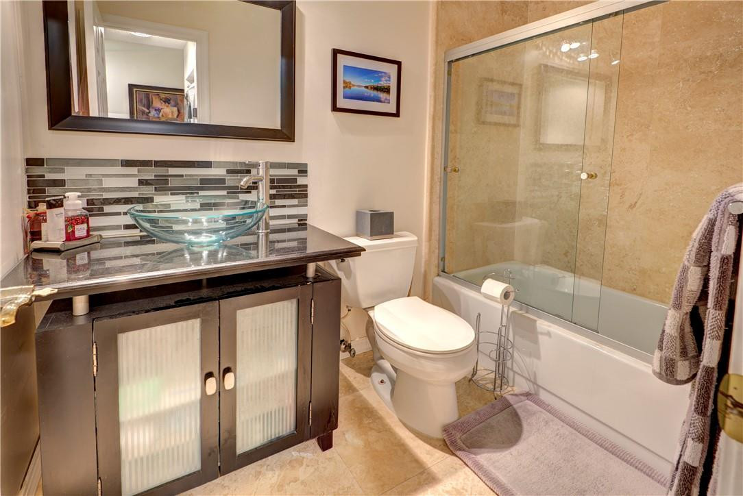 3130 Millwood Terrace, Unit M210 Boca Raton, FL 33431 - Photo 12 of 23 a bathroom with a sink a toilet and shower
