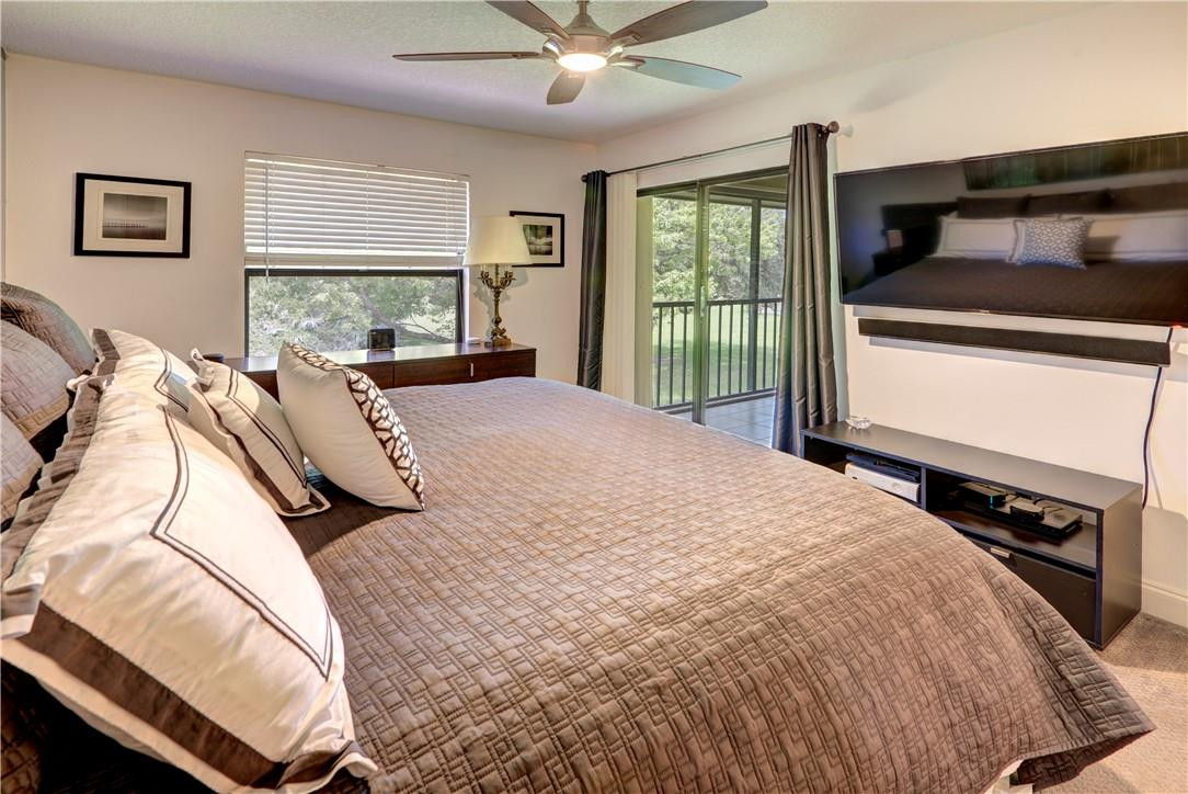 3130 Millwood Terrace, Unit M210 Boca Raton, FL 33431 - Photo 14 of 23 a bedroom with a bed and window