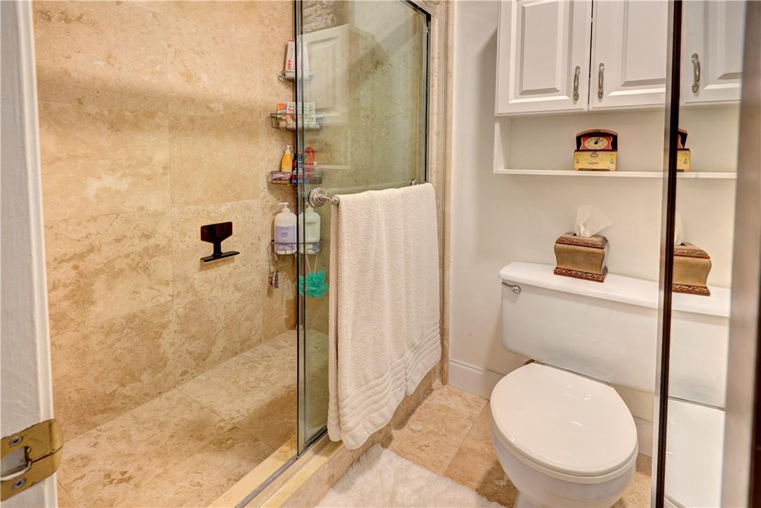 3130 Millwood Terrace, Unit M210 Boca Raton, FL 33431 - Photo 18 of 23 a bathroom with a toilet and a shower