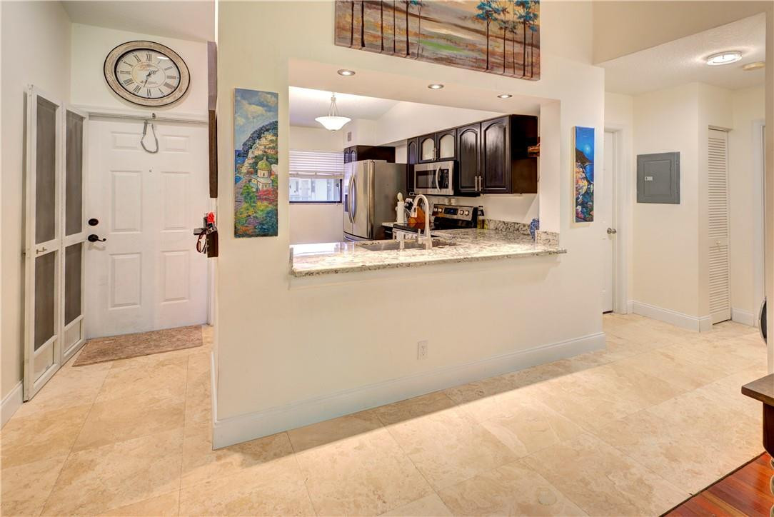 3130 Millwood Terrace, Unit M210 Boca Raton, FL 33431 - Photo 5 of 23 a view of a kitchen cabinets and a window