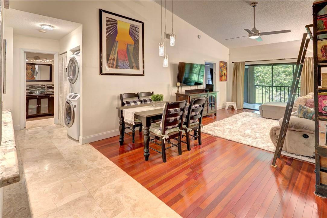 3130 Millwood Terrace, Unit M210 Boca Raton, FL 33431 - Photo 6 of 23 a view of a dining room with furniture window and wooden floor