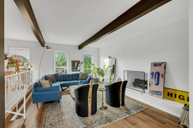 a living room with furniture rug and a window