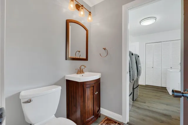 a view of a hallway with wooden floor and stairs