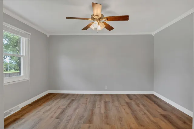 wooden floor in an empty room with a window