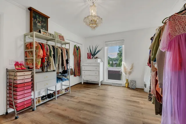 a view of walk in closet with clothes and shoes