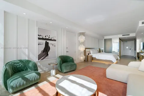 a bedroom with furniture and a large window
