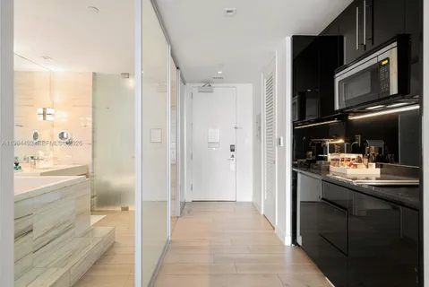 a kitchen with stainless steel appliances granite countertop a refrigerator and a microwave