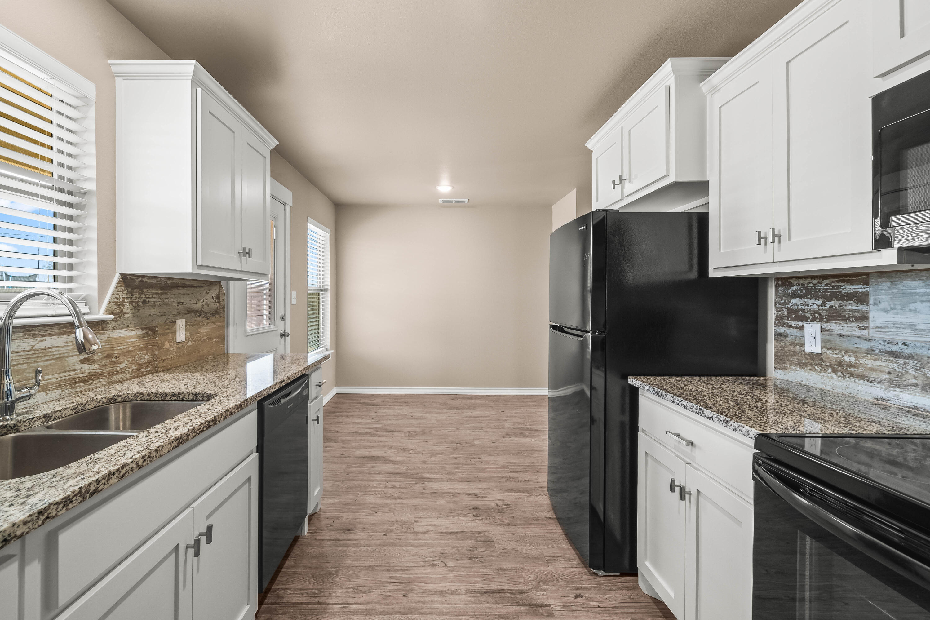 4202 East 64th Street Lubbock, TX 79403 - Photo 9 of 19 a kitchen with a sink stove and refrigerator