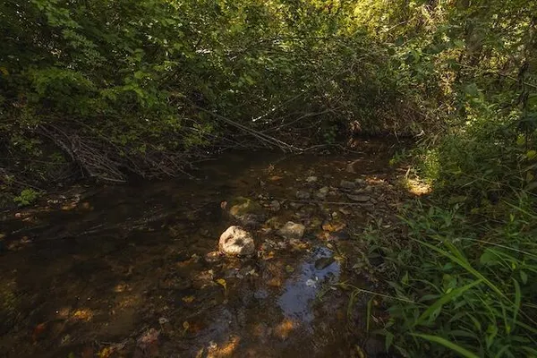 a view of a big yard with an outdoor space and seating area
