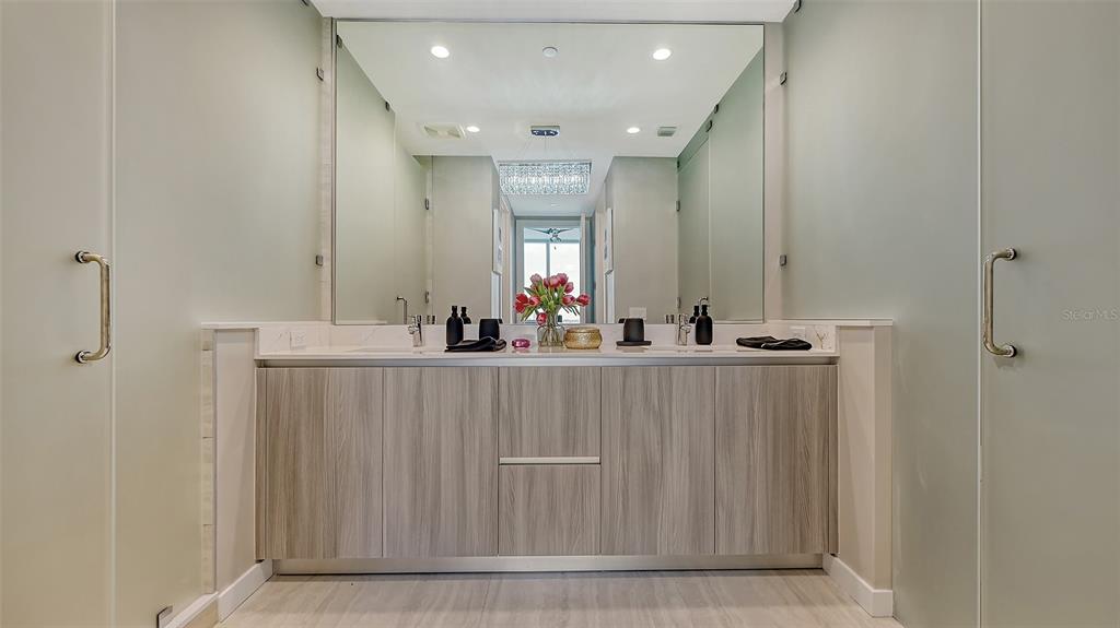 301 Quay Commons, Unit 606 Sarasota, FL 34236 - Photo 11 of 36 a view of a hallway with mirror and window