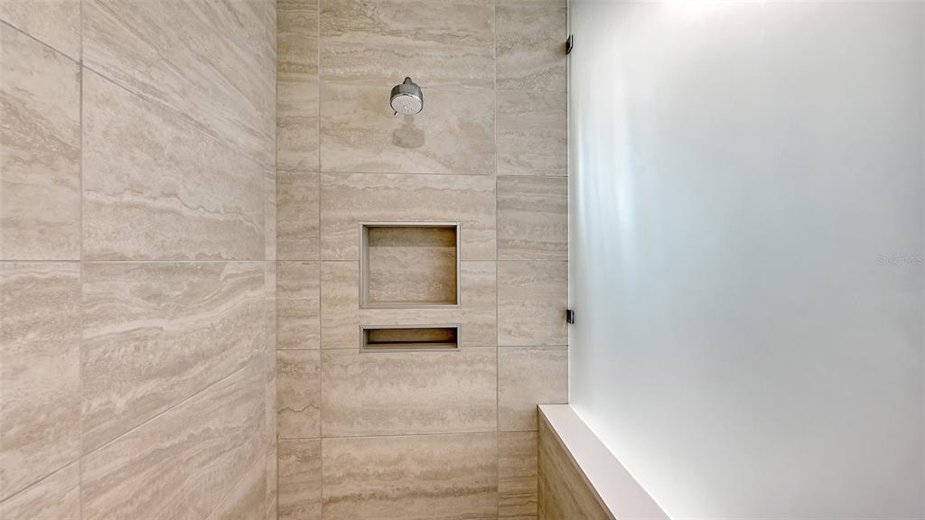 301 Quay Commons, Unit 606 Sarasota, FL 34236 - Photo 13 of 36 a bathroom with a shower
