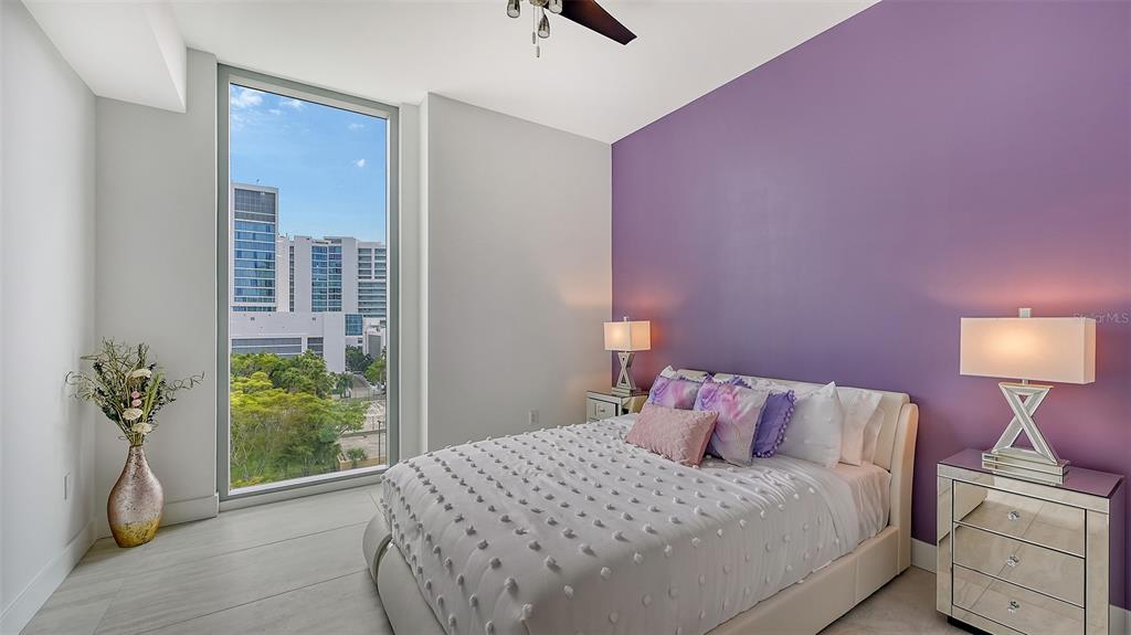 301 Quay Commons, Unit 606 Sarasota, FL 34236 - Photo 21 of 36 a bedroom with a bed and a potted plant