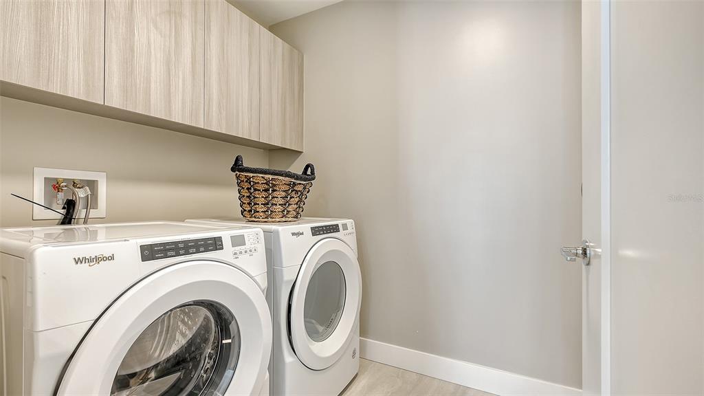 301 Quay Commons, Unit 606 Sarasota, FL 34236 - Photo 23 of 36 a view of washer and dryer