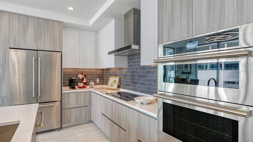 301 Quay Commons, Unit 606 Sarasota, FL 34236 - Photo 6 of 36 a kitchen with stainless steel appliances a refrigerator and a sink