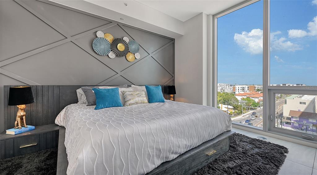 301 Quay Commons, Unit 606 Sarasota, FL 34236 - Photo 10 of 36 a bedroom with a bed and window