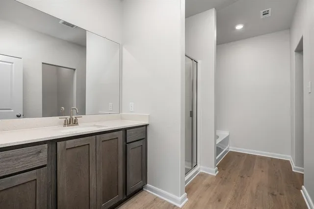 a bathroom with a double vanity sink and mirror