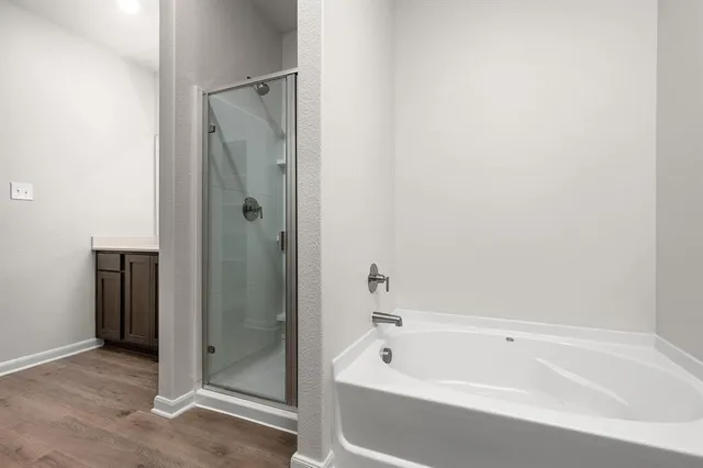 a bathroom with a bathtub and a shower
