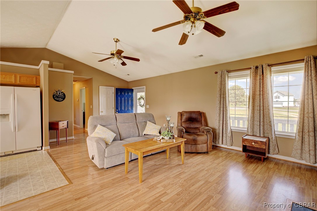 118 Edwards Court Dutton, VA 23050 - Photo 13 of 24 Living room featuring ceiling fan, lofted ceiling, and light hardwood / wood-style flooring