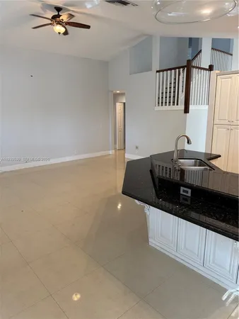a kitchen with granite countertop a stove and a sink
