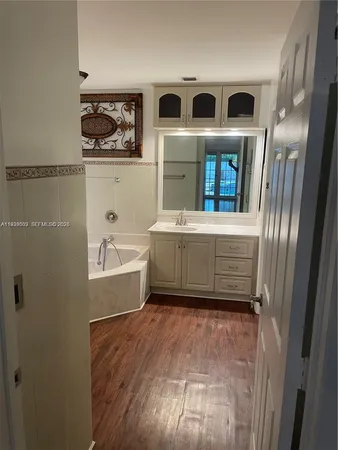 a bathroom with a bathtub and shower