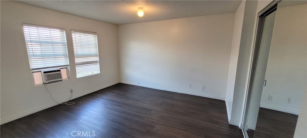 16332 Trelaney Road Fontana, CA 92337 - Photo 5 of 8 a view of an empty room with wooden floor and a window