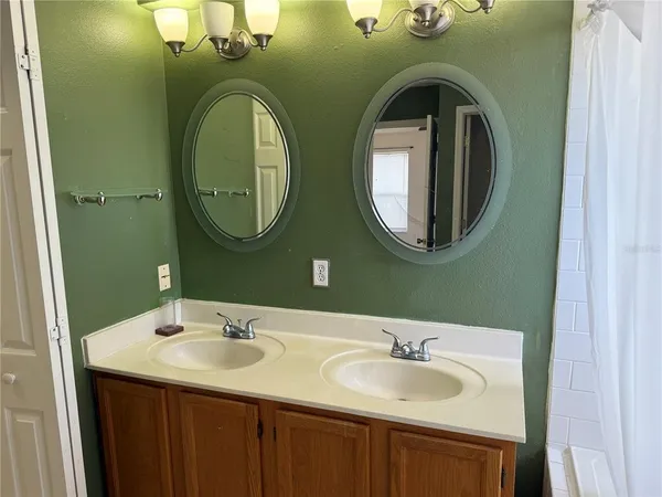 a bathroom with a double vanity sink and mirror