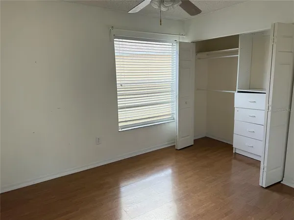 an empty room with windows and closet