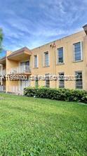 13700 Southwest 62nd Street, Unit 221 Miami, FL 33183 - Photo 3 of 3 a front view of house with yard and green space