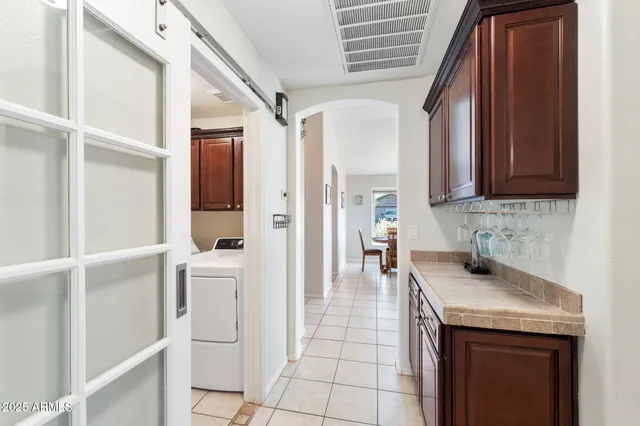 a kitchen with stainless steel appliances granite countertop a sink and a refrigerator