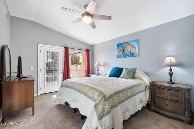 a room with a bed and a ceiling fan
