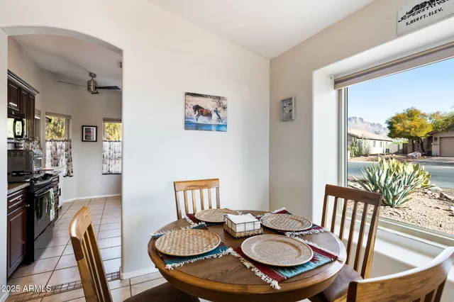 a view of a dining room with furniture a kitchen and wooden floor