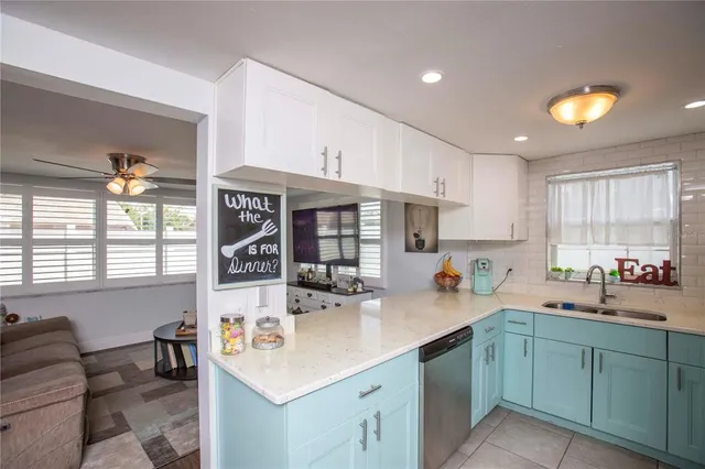 a kitchen that has a sink and a stove in it