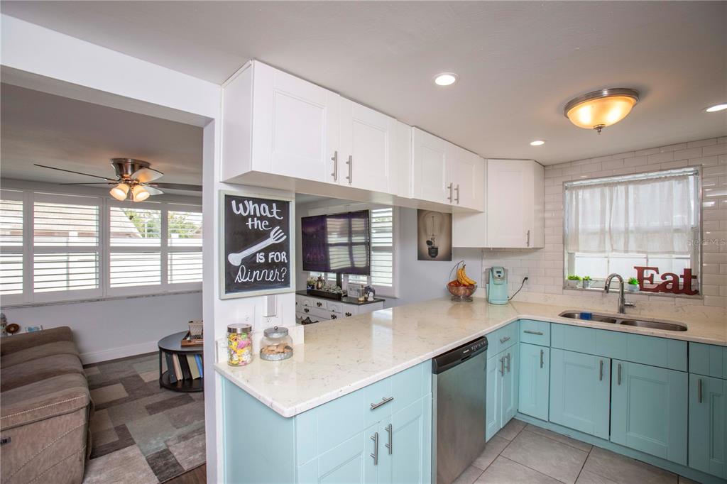 5240 School Road New Port Richey, FL 34653 - Photo 11 of 32 a kitchen that has a sink and a stove in it