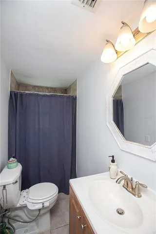 a bathroom with a sink a toilet and mirror