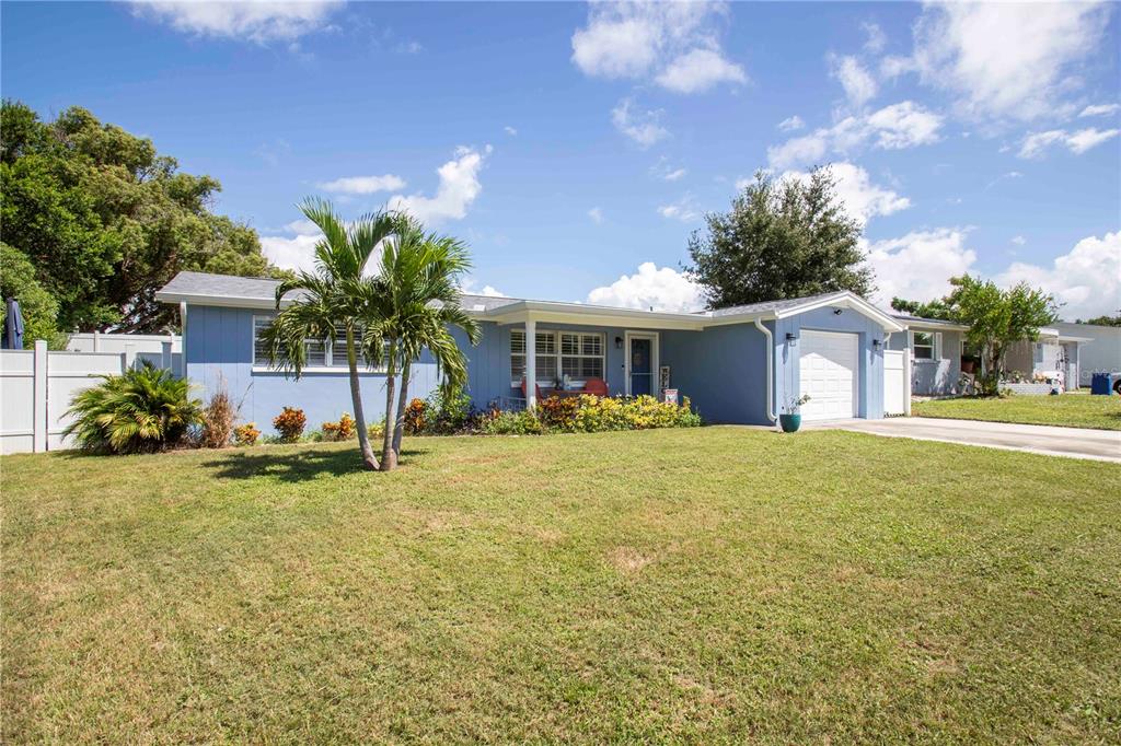 5240 School Road New Port Richey, FL 34653 - Photo 2 of 32 a front view of a house with a yard and garage