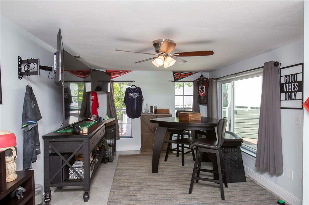5240 School Road New Port Richey, FL 34653 - Photo 23 of 32 a view of a dining room with furniture window and outside view